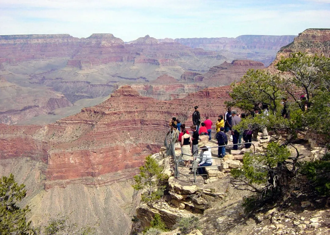 VISITORS VIEWING THE CANYON FROM YAVAPAI OBSERVATION STATION ON THE SOUTH RIM OF GRAND CANYON NATIONAL PARK.