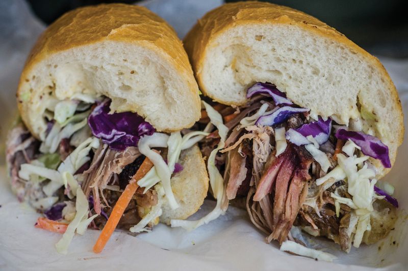 Cochon de lait (suckling-pig / festival po’boy) — Walker’s Southern Style BBQ (New Orleans / Jazz Fest tradition)