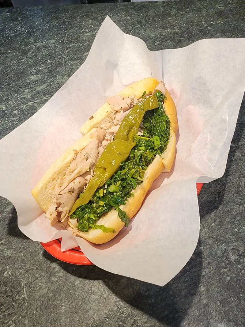 The signature roast pork with sharp provolone and broccoli rabe