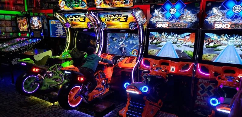 Modern Arcade Experiences Including Racing Sims and Giant Screen Games