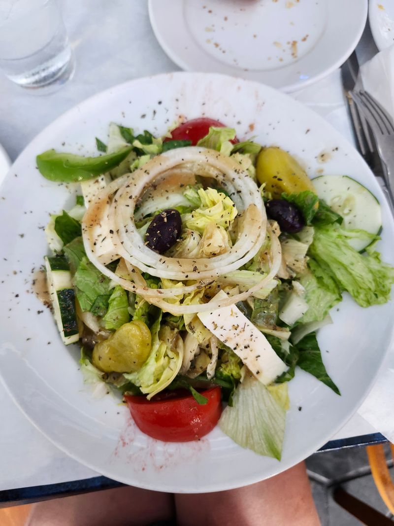 Greek salad with hidden potato salad