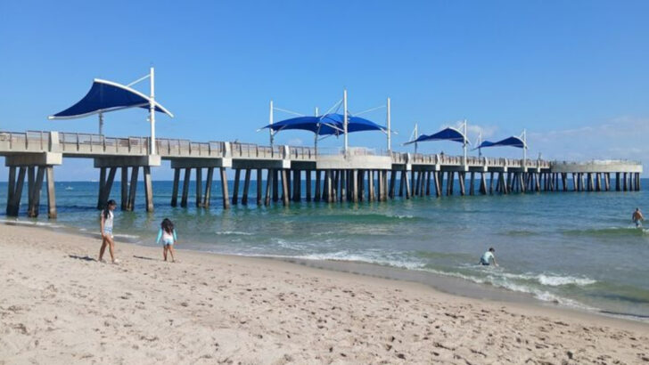 This Open Air Florida Beach Bar Sits Under a Giant Thatched Palapa Right at the Base of a 900 Foot Pier