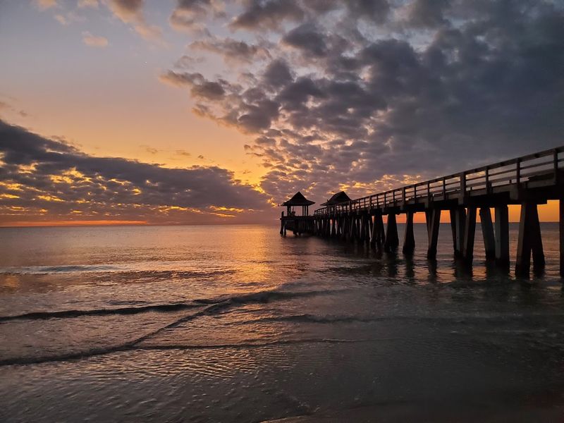 Watch dolphins, catch the sunset, and enjoy a casual waterfront dinner at Naples Pier