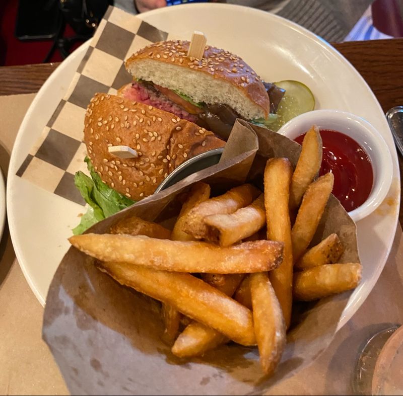 A Classic Burger With A Polished Twist A Plate Of Crispy, Golden Fries