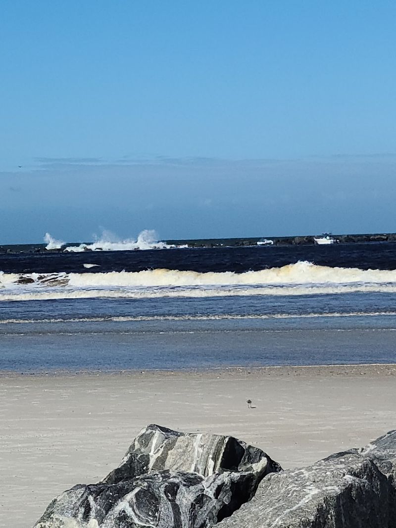A quiet boardwalk, a busy tide - Smyrna Dunes Park Beach