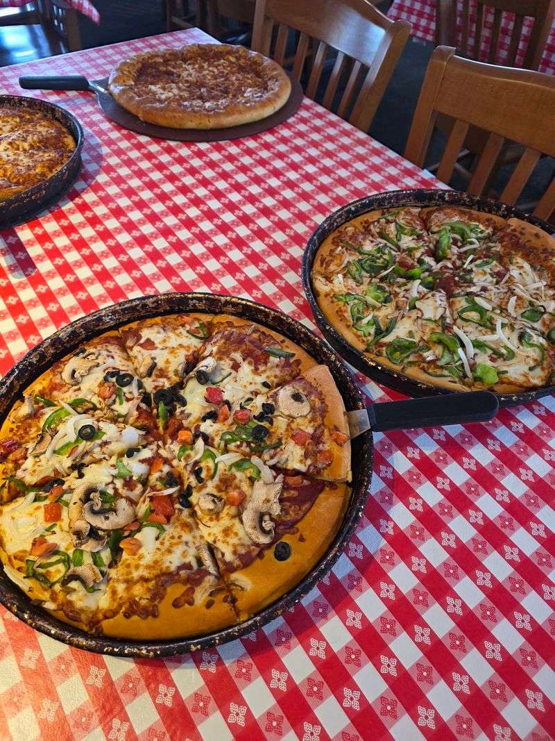 Pan Pizza Served In Hot Skillets