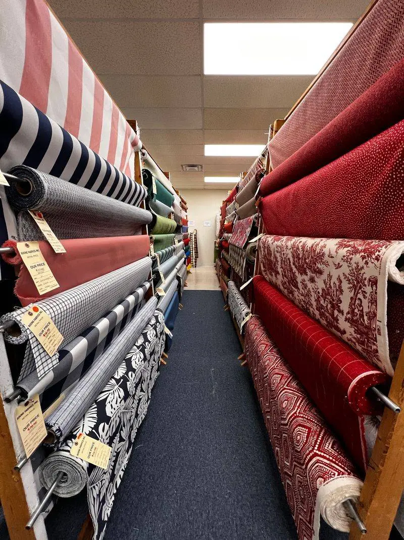 Aisles Of Towering Rolls Arranged By Color