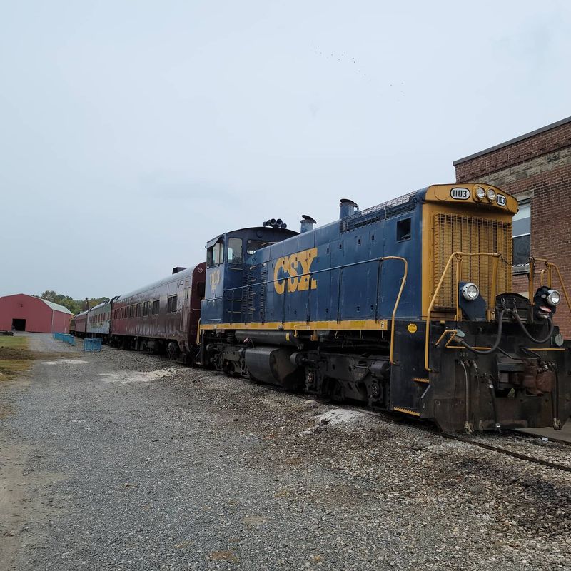 Walking Among Historic Cars Along The Tracks