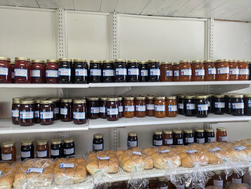 Pantry Shelves Stocked With Jams, Honey, And Homemade Granola