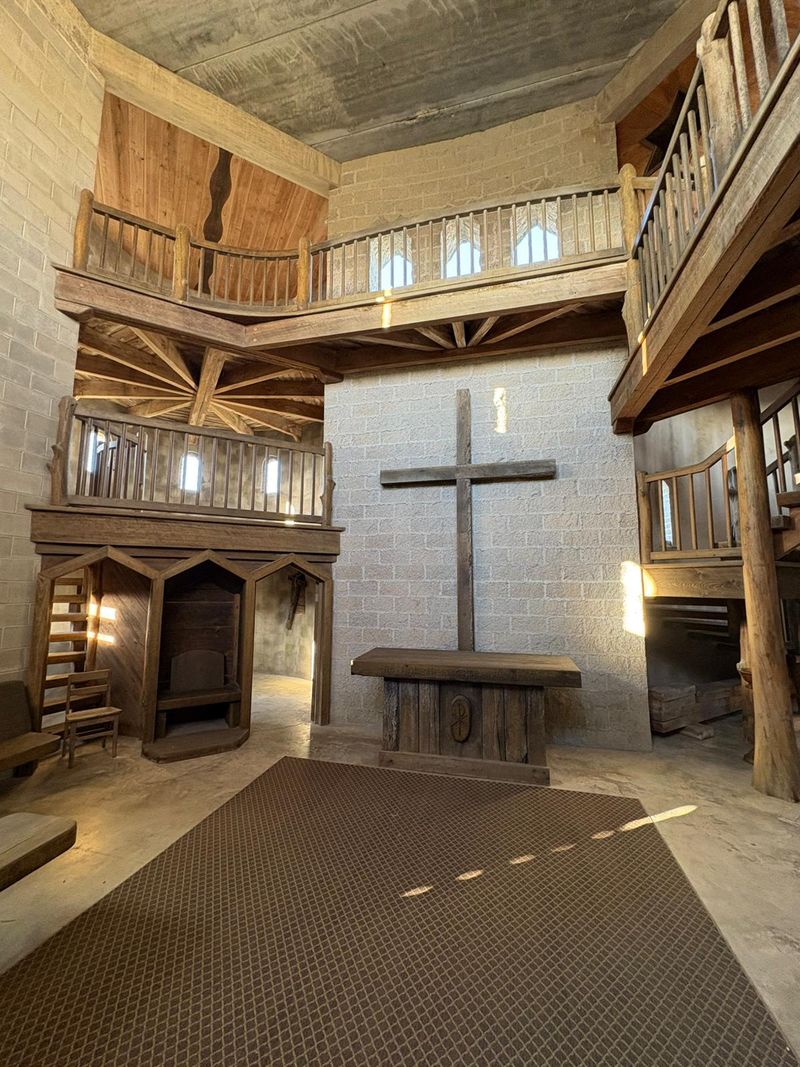 An Altar, Pews, And A Bishop's Chair Wait Inside