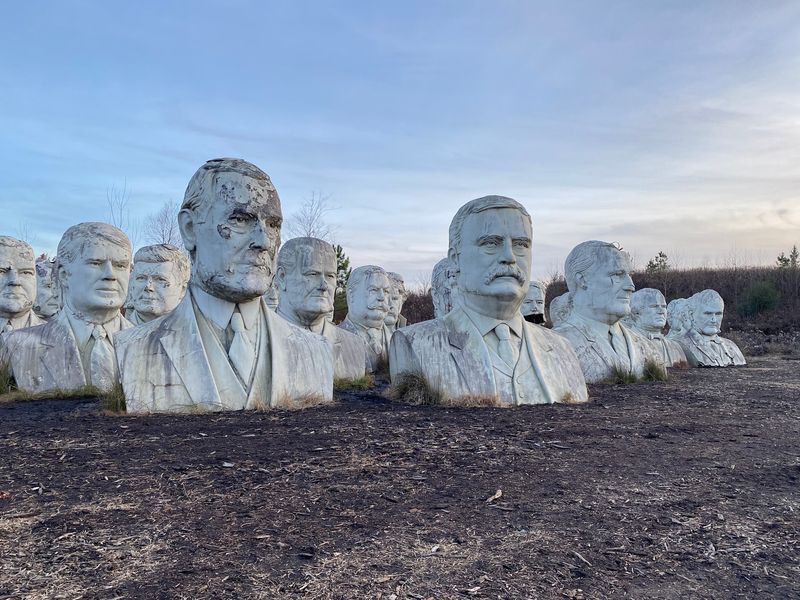 Forty-Two Concrete Presidents Are Waiting In A Very Muddy Field