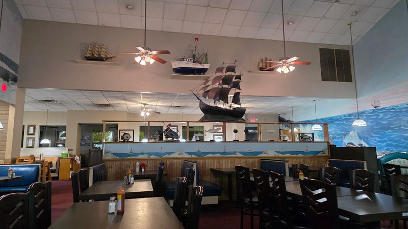Blue Booths And A Harbor Mural Set The Mood Without Trying Too Hard