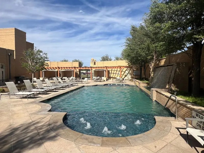 A Leafy Courtyard Where the Hot Tub Steals the Show