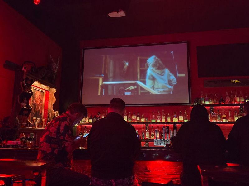 A Neighborhood Bar Where The Lights Stay Low And The Movies Stay Scary