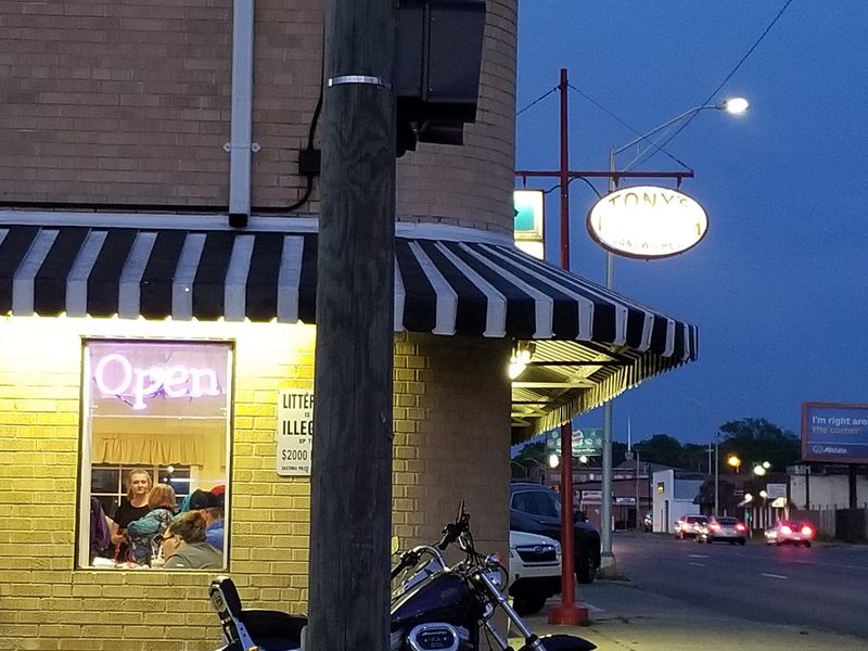 Look For The Red Sign And Striped Awning